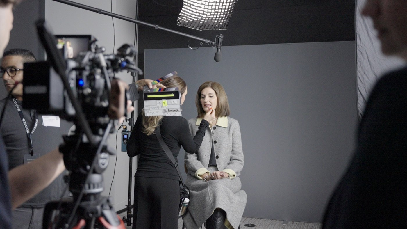 Hair and makeup artist preparing a guest in Film Label’s on-site executive interview studio.